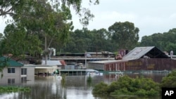 FILE - Buildings are surrounded by flood waters in Londonderry on the outskirts of Sydney, Australia, March 3, 2022.