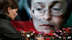 روسی صحافی ایناپولیٹکوسکایا کے لئے پھول پیش کرتی ایک خاتون