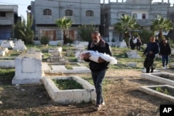 فلسطینی اسرائیل کی بمباری میں ہلاک ہونے والے اپنے عزیزوں کو قبرستان میں تدفین کے لیے لا رہے ہیں، فوٹو اے پی 22 دسمبر 2023