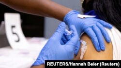 USA, Philadelphia, A woman receives a COVID-19 vaccine 