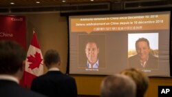 Ảnh của Michael Kovrig và Michael Spavor tại Đại sứ quán Canada ở Bắc Kinh hôm 11/8/2021.