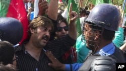 اسلام آباد، مارچ 18، 2011، پولیس کے سپاہی جمعہ کے روز مظاہرین کو امریکی سفارت کانے تک پہنچنے سے روک رہے ہیں۔