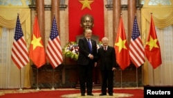 U.S. President Donald Trump shakes hands with Vietnamese President Nguyen Phu Trong