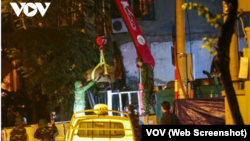 Lực lượng công binh di chuyển quả bom nặng 340kg, được cho là sót lại từ thời chiến tranh và được phát hiện tại một công trường thi công giữa thủ đô Hà Nội, hôm 29/11. (Ảnh chụp màn hình VOV)