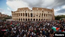Người dân cầm cờ Palestine trước Đấu trường La Mã Colosseum trong một cuộc biểu tình ủng hộ người Palestine ở Gaza, tại Rome, Ý, ngày 28 tháng 10 năm 2023.